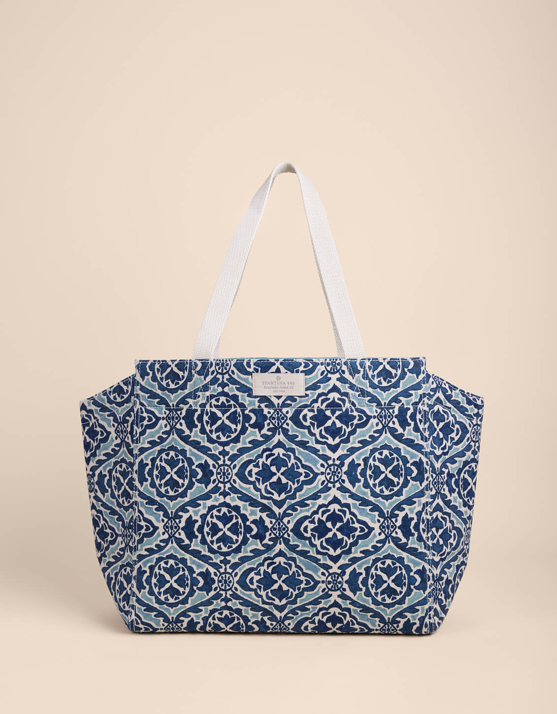 Blue patterned tote bag on a beige background