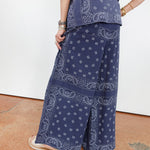 Person wearing a blue paisley patterned outfit on a white background