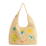 Woven handbag with beach-themed decorations on a white background