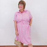 Woman wearing a pink outfit with a white background