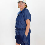 Woman wearing a blue dress and white cap with text against a white background