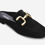 Black slip-on shoe with gold buckle on a white background