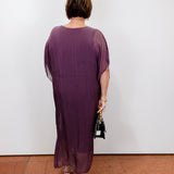 model wearing the helen silk kaftan long dress in eggplant with a flowy silhouette