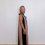 Women's sleeveless maxi dress with black and taupe colorblock design against a white background. 