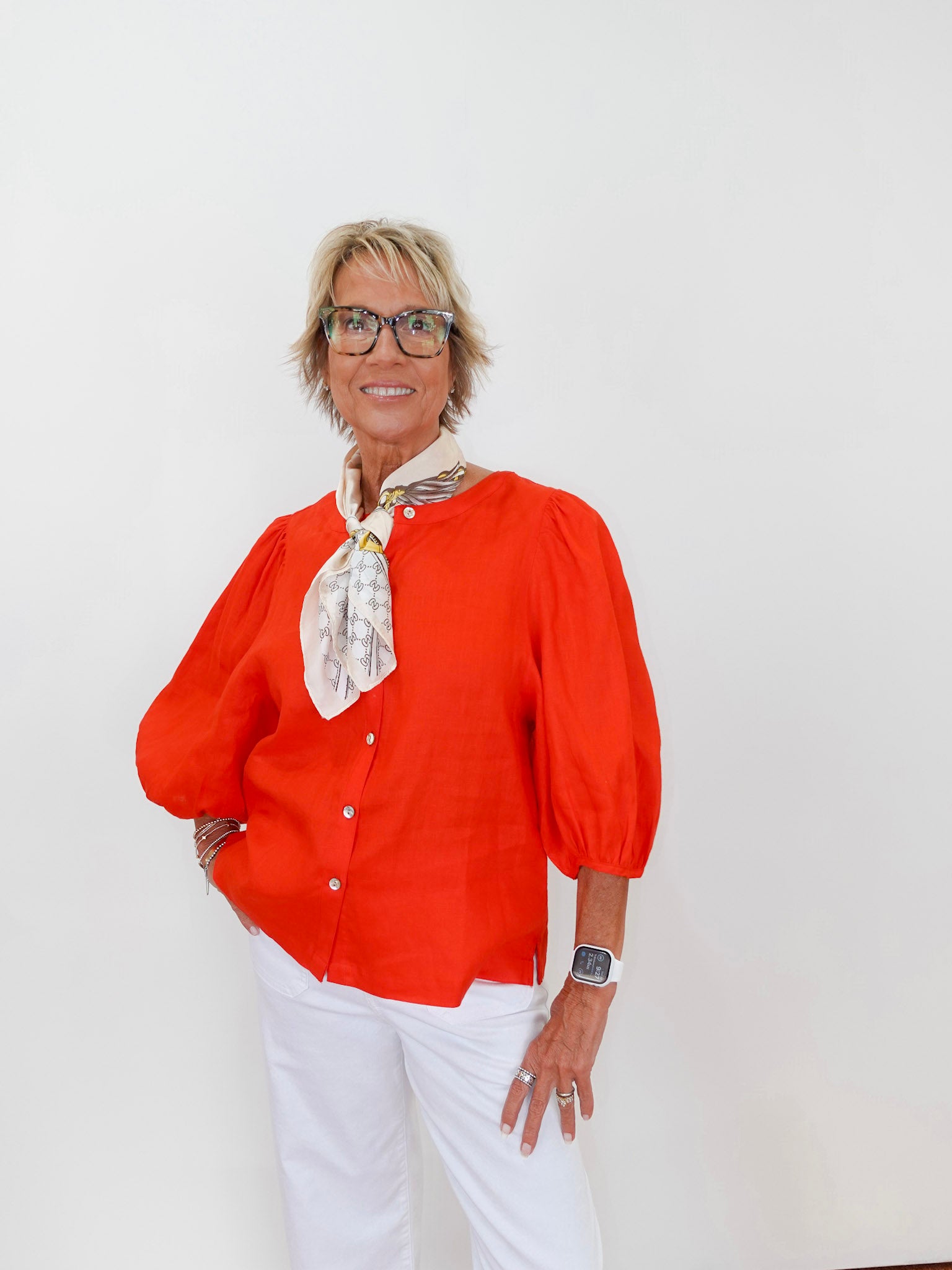 Person wearing an orange blouse with a white background