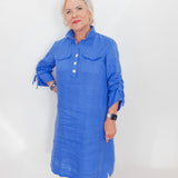 Woman wearing a blue dress against a white background