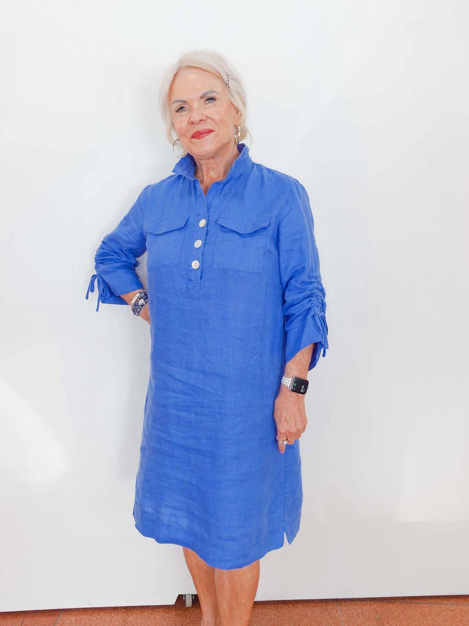 Woman wearing a blue dress against a white background