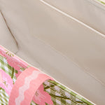 Close-up of a pink floral-patterned product on a beige surface