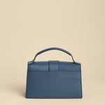 Blue handbag on a beige background