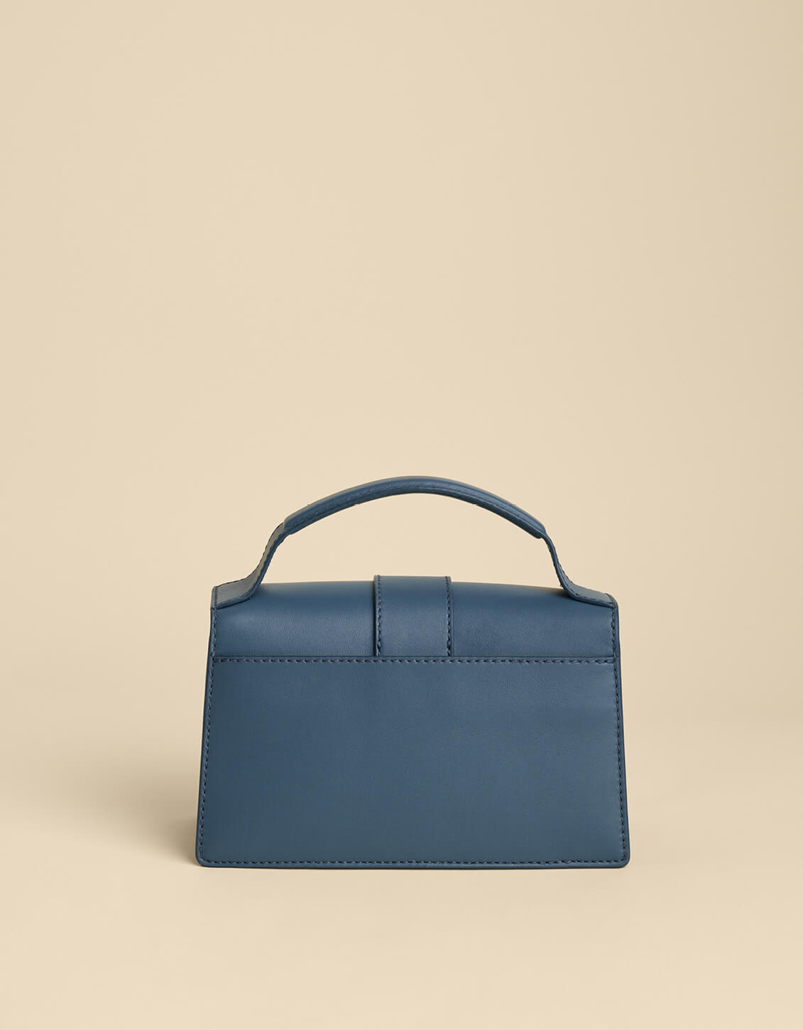 Blue handbag on a beige background