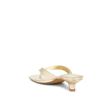 Gold high-heeled sandal on a white background
