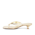 Gold high-heeled sandal on a white background