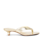 Gold high-heeled sandal on a white background
