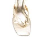Gold sandal on a white background