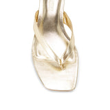 Gold sandal on a white background