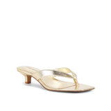 Gold high-heeled sandal on a white background