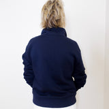 Person wearing a navy blue jacket against a white background