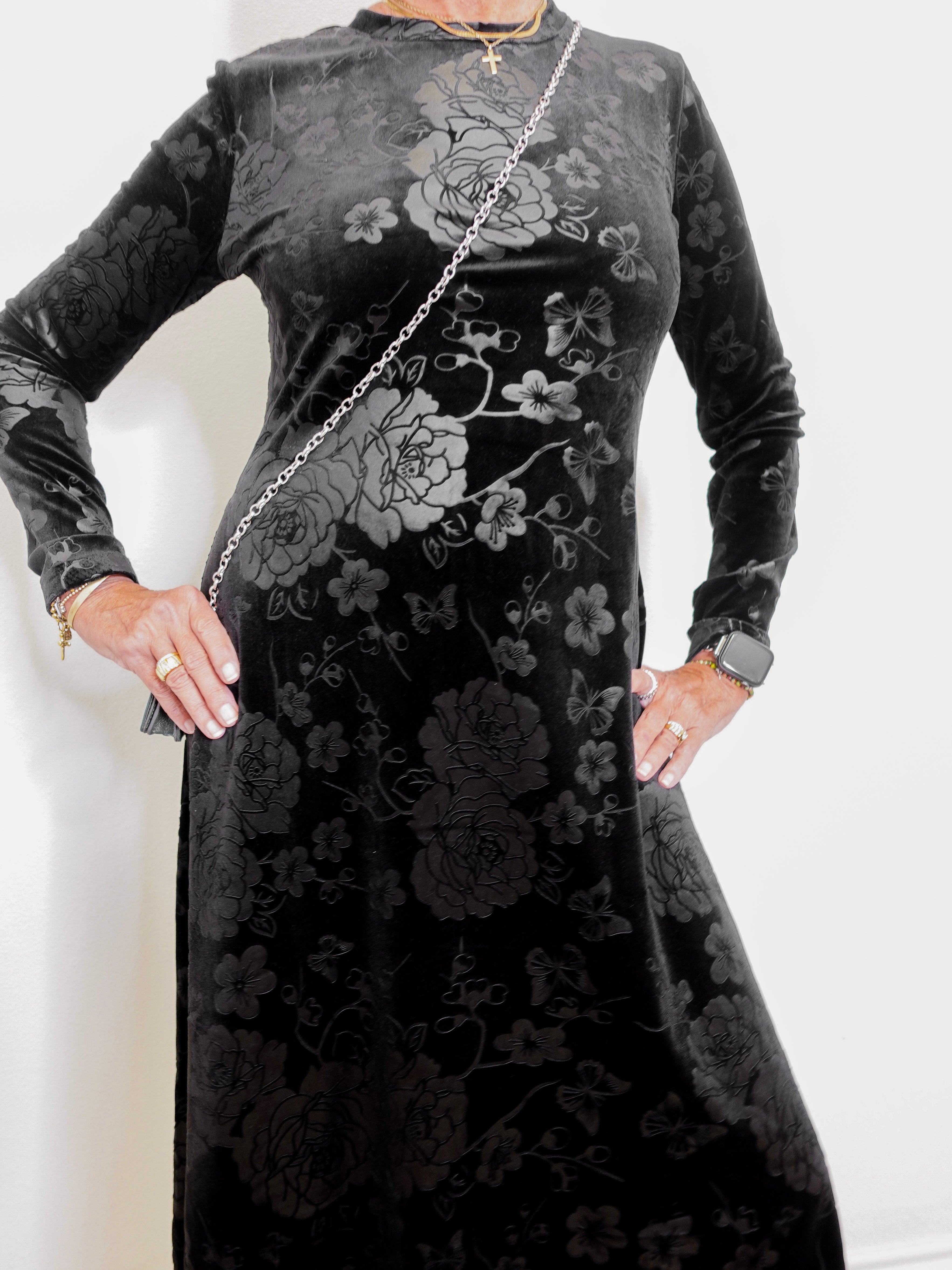 Black floral dress with long sleeves on a white background