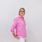 Woman wearing a pink striped shirt against a white background