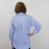 Person wearing a blue and white striped shirt against a plain background
