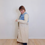 woman wearing a stylish denim mix trench coat against white background 