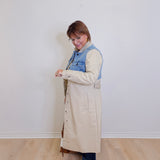woman wearing a stylish denim mix trench coat against white background 