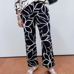 Woman wearing the FDJ Suzanne printed boot crop pant with a black and white abstract print.