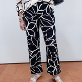 Woman wearing the FDJ Suzanne printed boot crop pant with a black and white abstract print.