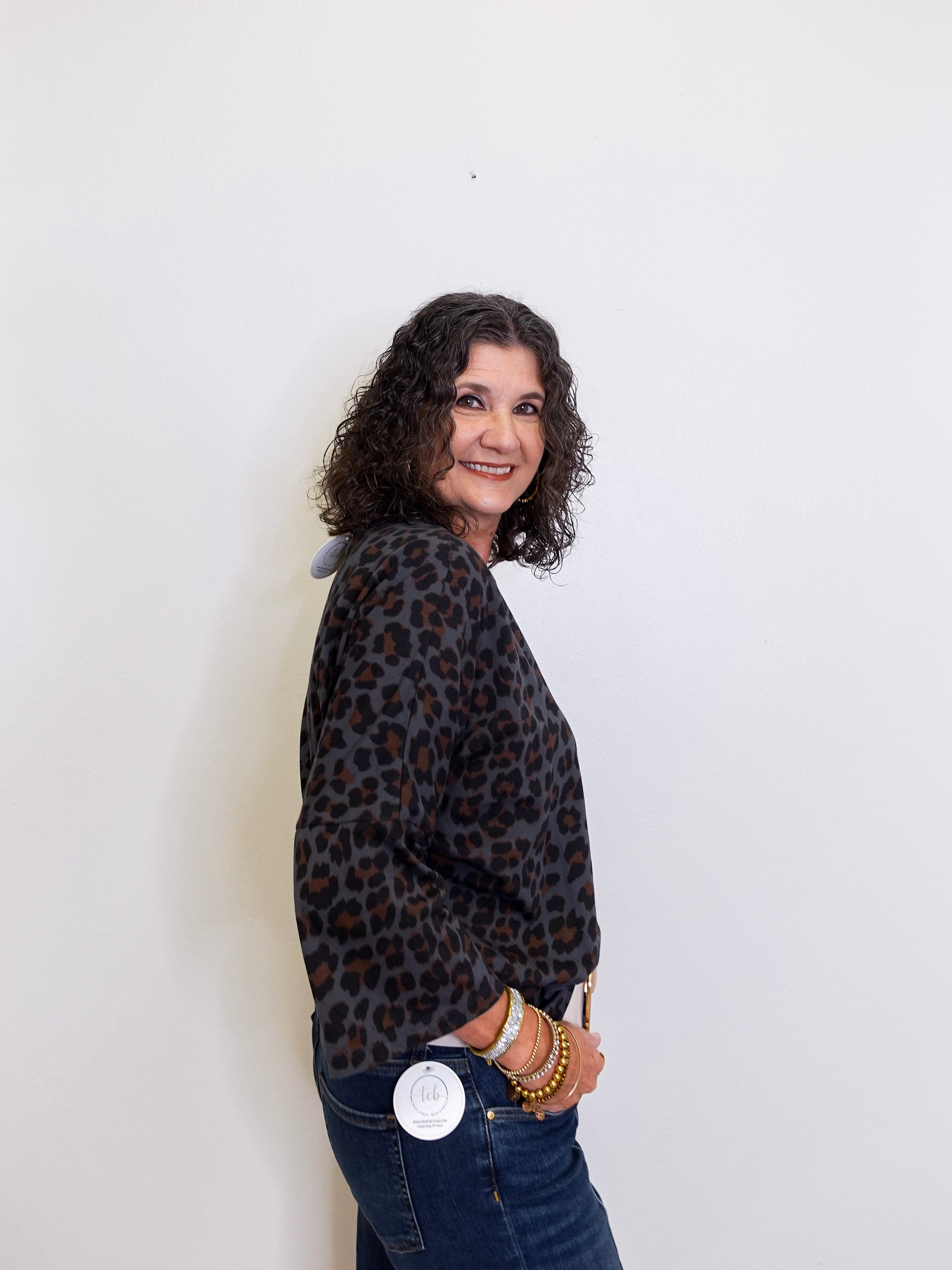 Woman wearing a leopard print jacket against a white background