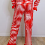 Red and white striped outfit with ruffled pants on a plain background