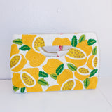 Clutch bag with lemon pattern on a white background