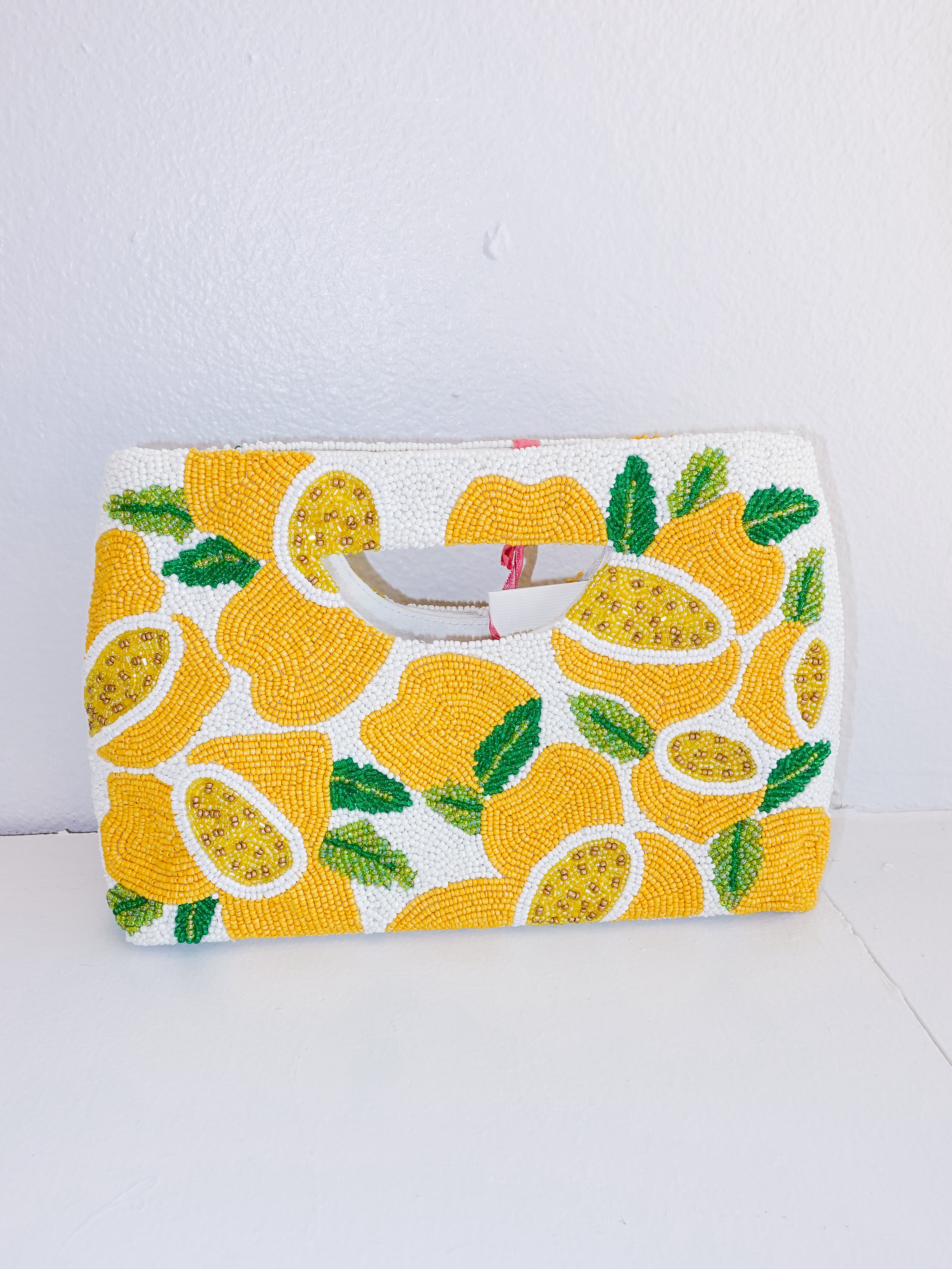 Clutch bag with lemon pattern on a white background