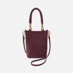 Burgundy handbag with gold accents on a white background