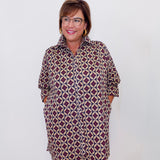 Woman wearing a patterned dress against a white background