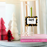 Tart by Taylor diffuser on a table with decorative trees and books