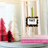 Tart by Taylor diffuser on a table with decorative trees and books
