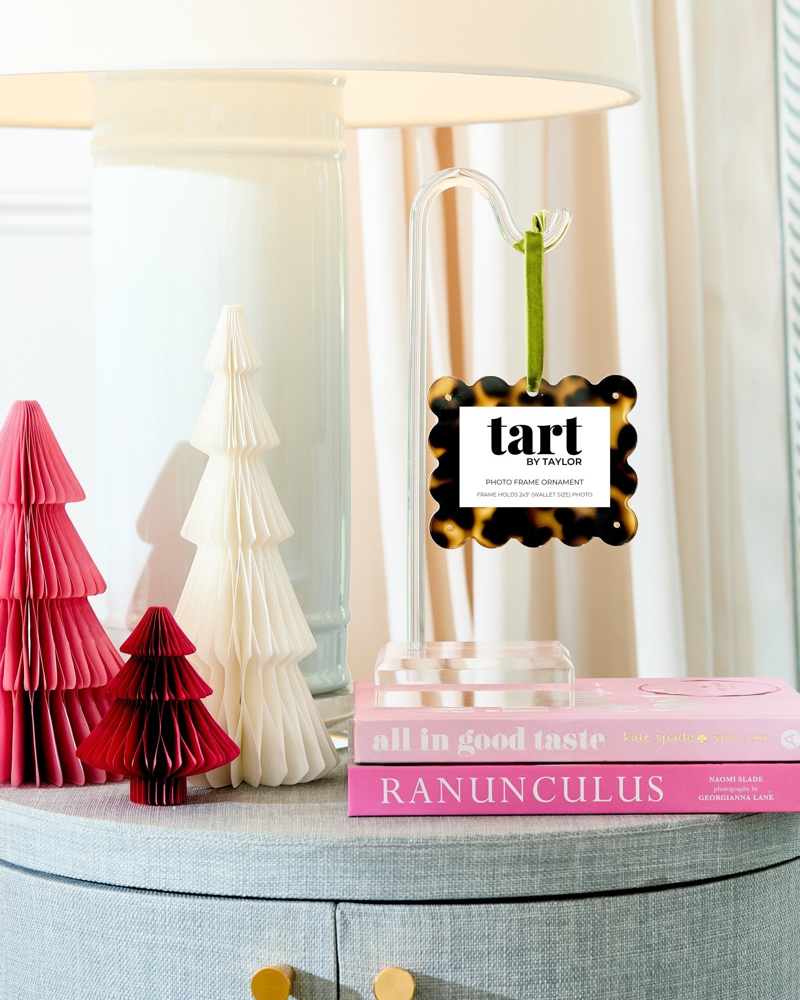 Tart by Taylor diffuser on a table with decorative trees and books