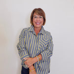 Woman wearing a striped shirt against a plain background