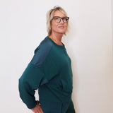 Woman wearing a green outfit against a white background
