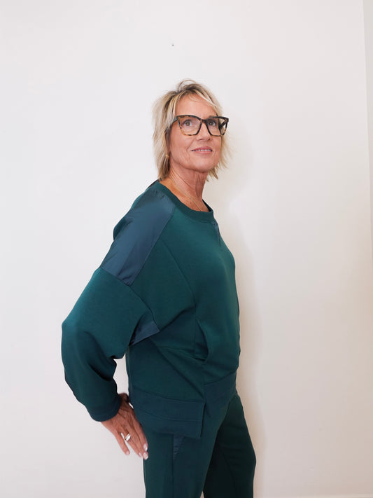 Woman wearing a green outfit against a white background