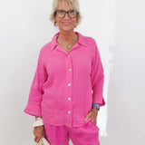 Woman wearing a pink outfit against a white background