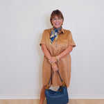 woman wearing a tribal short sleeve dress that's a tan suede. 
