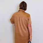 woman wearing a suede tribal short sleeve dress with pockets. 