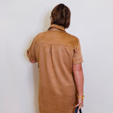 woman wearing a suede tribal short sleeve dress with pockets. 