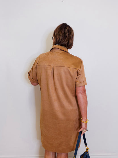 woman wearing a suede tribal short sleeve dress with pockets. 