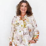 Woman wearing a floral blouse against a white background