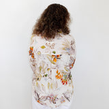 Person wearing a floral shirt with a white background