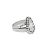 Silver ring with a teardrop-shaped gemstone on a white background