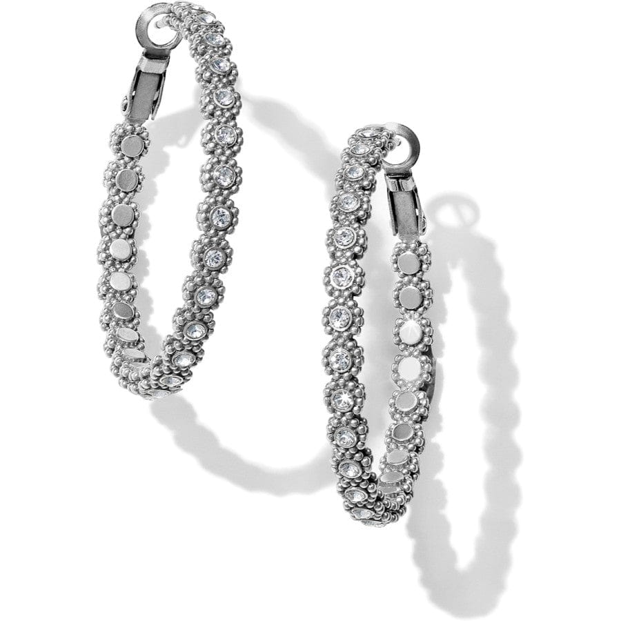 Pair of silver hoop earrings with clear gemstones on a white background