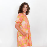 Woman wearing a floral dress against a white background